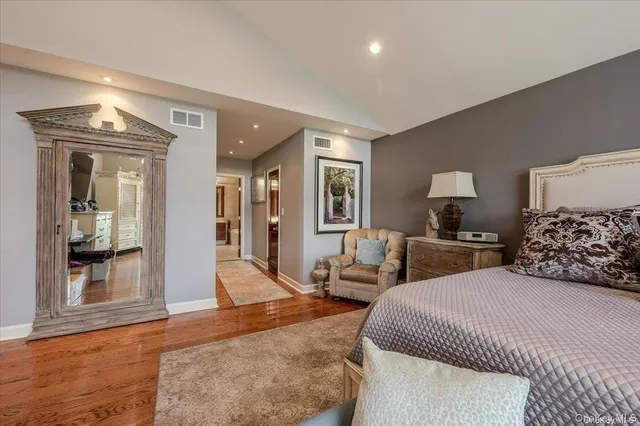 a bathroom with a bathtub sink and mirror