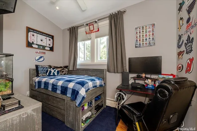 a bedroom with a large bed and a flat tv screen