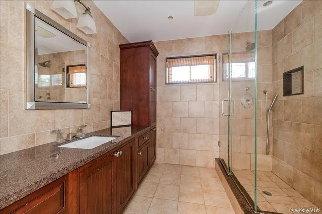 a bathroom with a double vanity sink and mirror