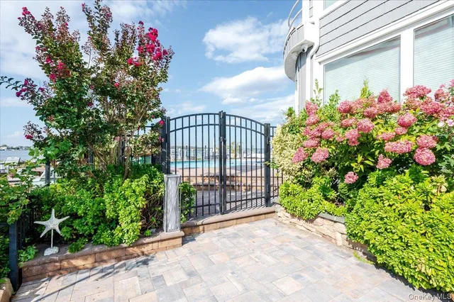 an outdoor sitting area with furniture and garden