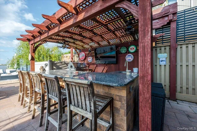 an aerial view of a house with swimming pool and outdoor seating