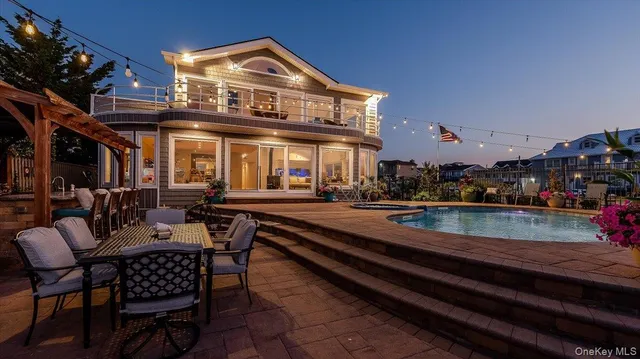 a view of a house with pool and chairs