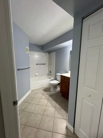 a spacious bathroom with a toilet and a shower