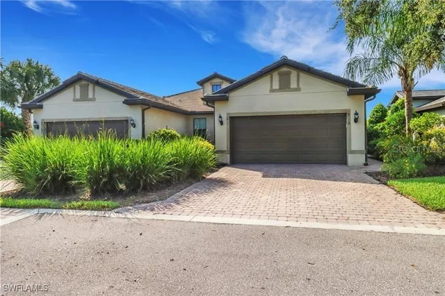a front view of a house with a yard and garage