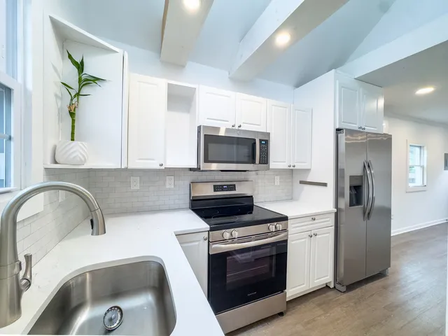 a kitchen with a sink cabinets and stainless steel appliances