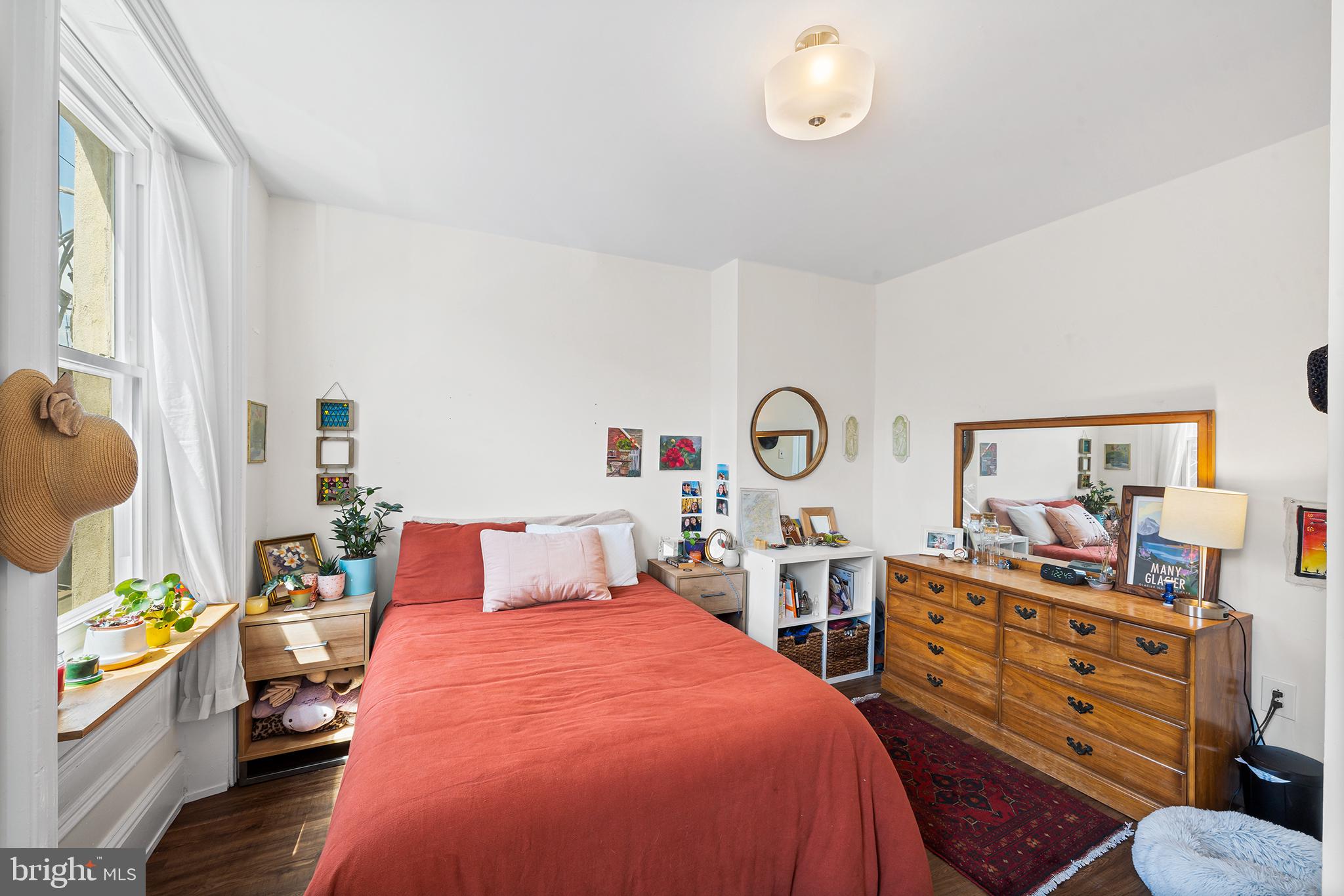 107 Master Street Philadelphia, PA 19122 - Photo 20 of 24 a bedroom with a bed and wooden floor