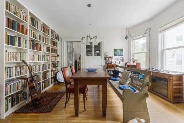 a view of a livingroom with furniture and a book shelf