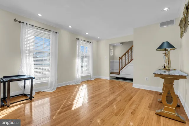 a view of a room with wooden floor staircase and a fireplace