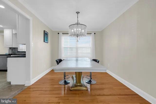 a view of a room with wooden floor staircase and a kitchen
