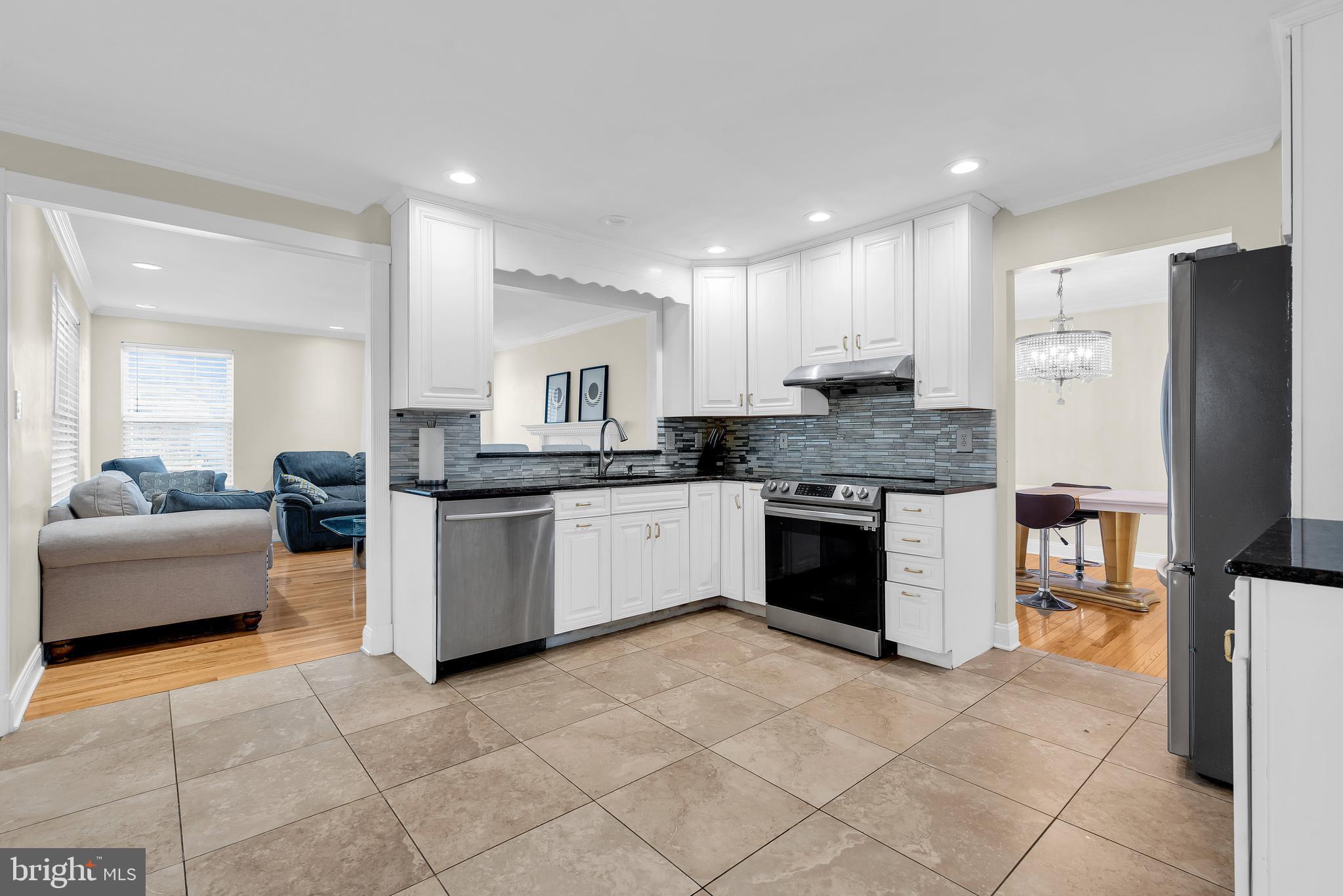12 Fawn Hollow Road Burlington, NJ 08016 - Photo 14 of 47 a kitchen with stainless steel appliances granite countertop a stove a sink dishwasher a refrigerator and white cabinets with wooden floor