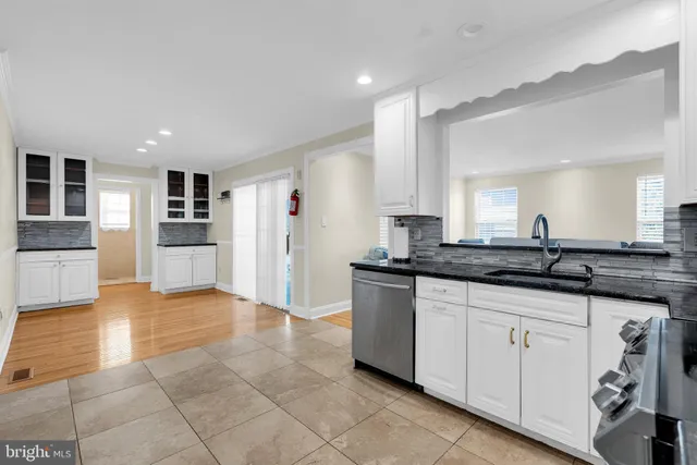 a large kitchen with cabinets and stainless steel appliances