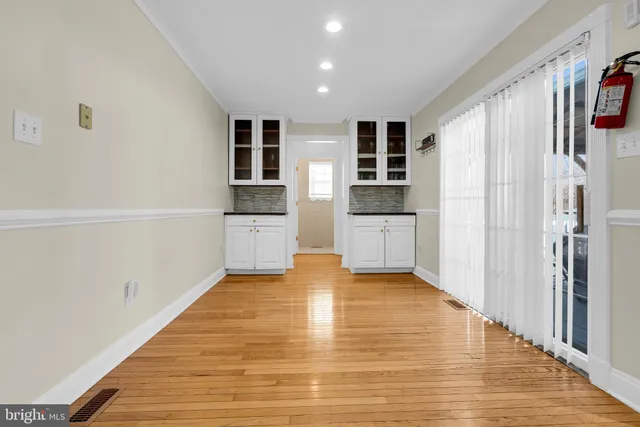 a view of a kitchen with wooden floor and electronic appliances