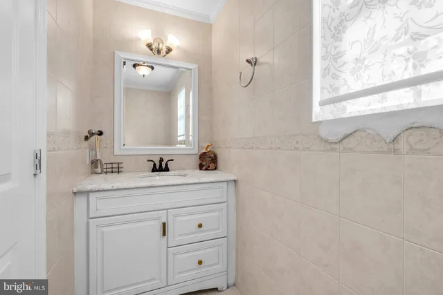 a bathroom with a sink vanity and mirror