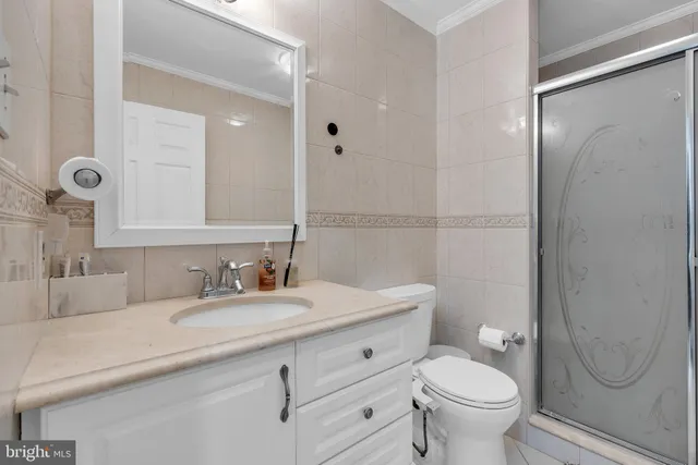 a bathroom with a granite countertop toilet sink and mirror
