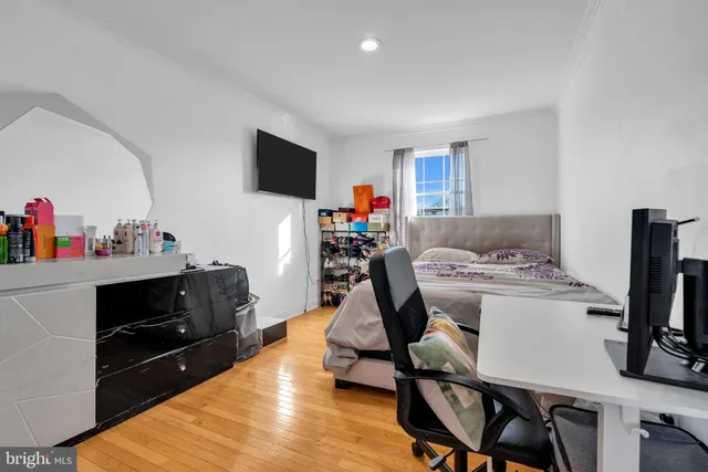 a view of a workspace with furniture and a flat screen tv