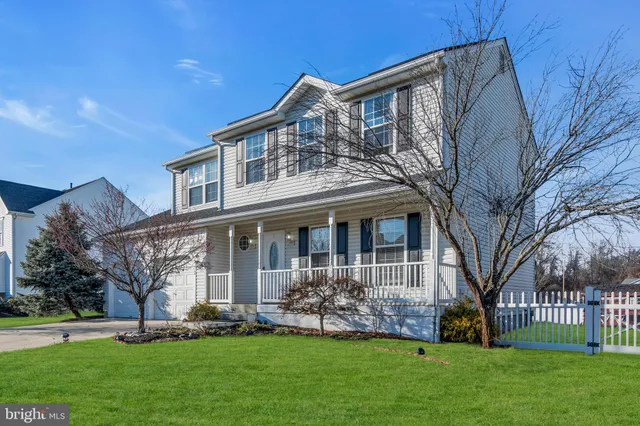 a front view of house with a garden