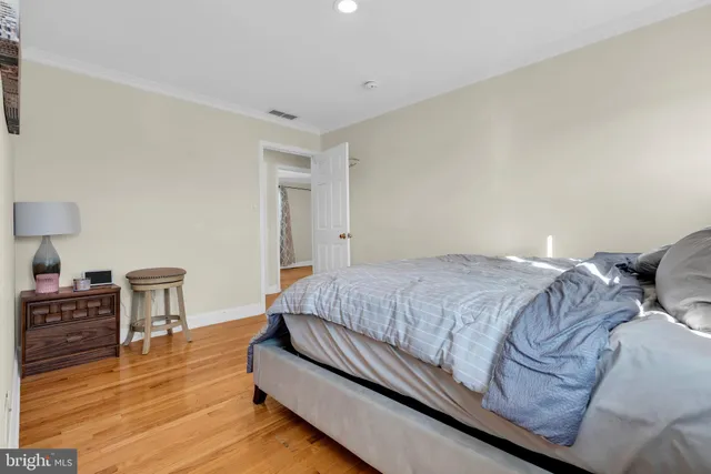 a bedroom with a bed and a table chair