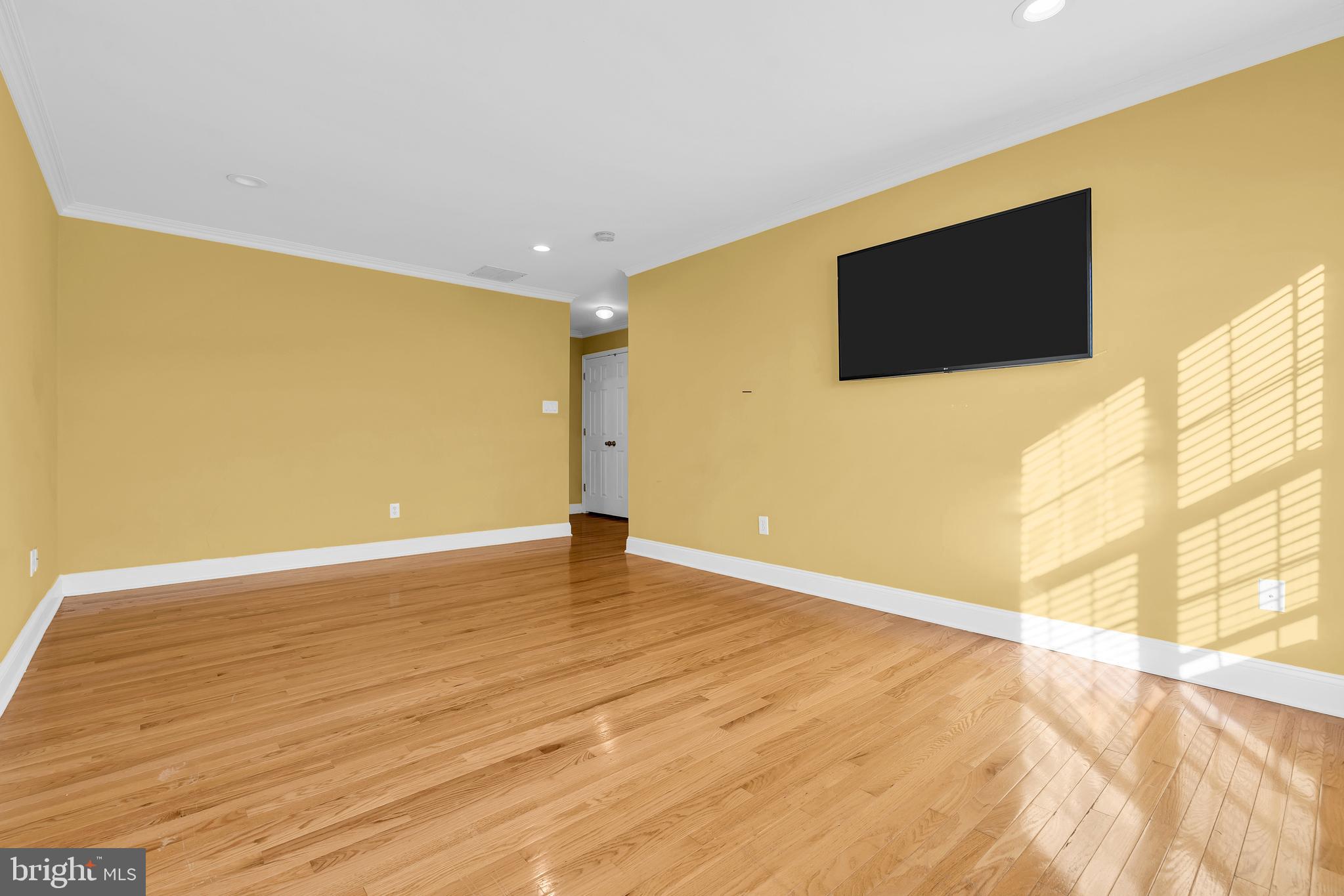 12 Fawn Hollow Road Burlington, NJ 08016 - Photo 33 of 47 a view of an empty room with wooden floor and a flat screen tv