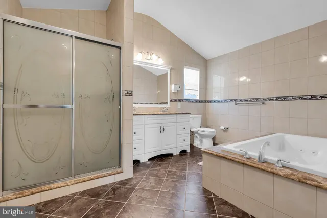 a bathroom with a granite countertop sink mirror and a bathtub