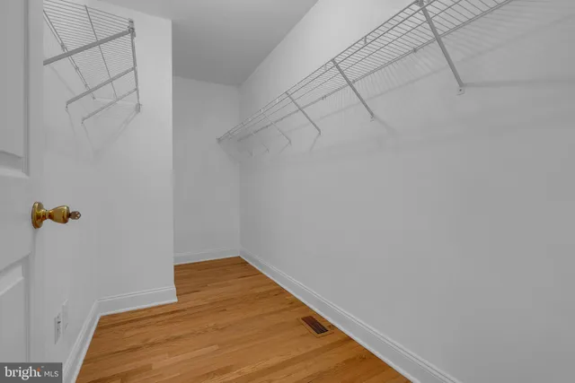 a bedroom with a bed and a wall painting