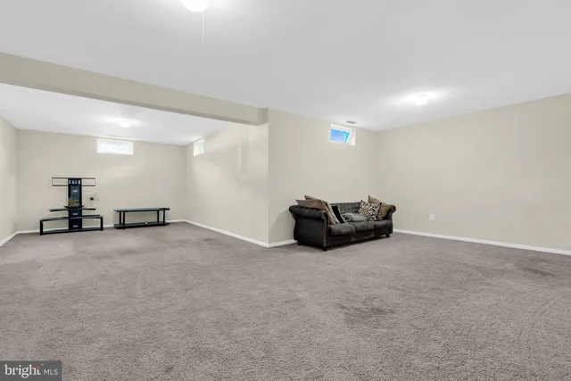 a big room with wooden floor and windows