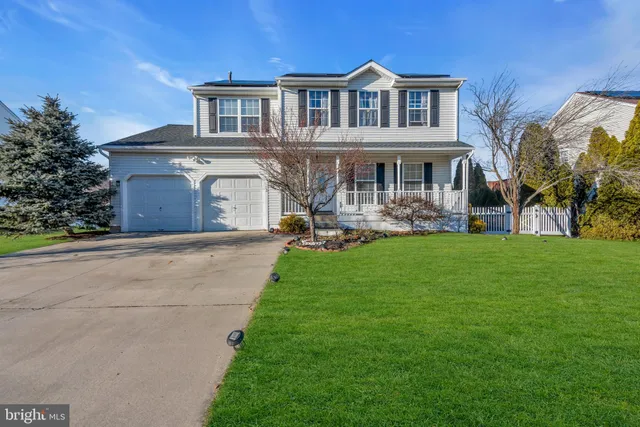 a front view of a house with garden and porch