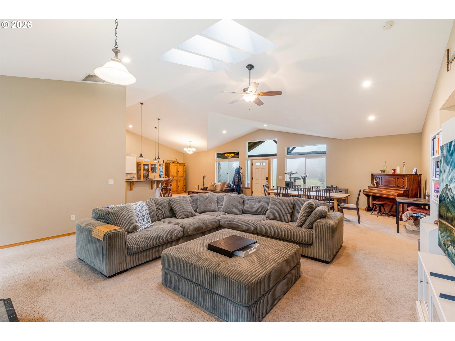 52365 Northwest Scofield Road Buxton, OR 97109 - Photo 13 of 48 a living room with furniture a chandelier and a flat screen tv