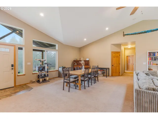 a dining room with furniture and a view of living room