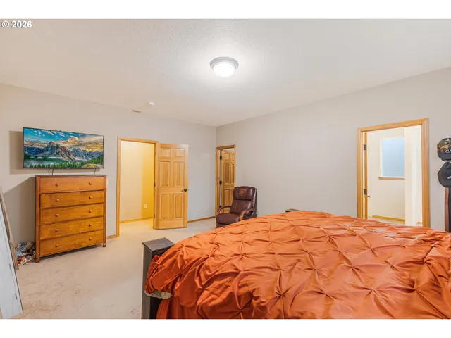 a bedroom with a bed and a dresser