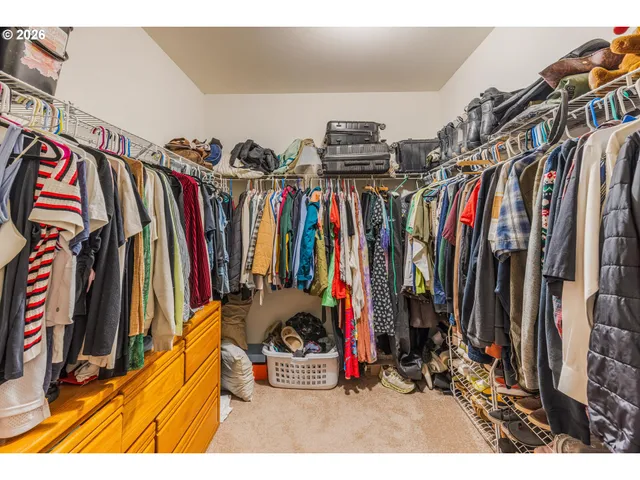 a view of walk in closet with clothes