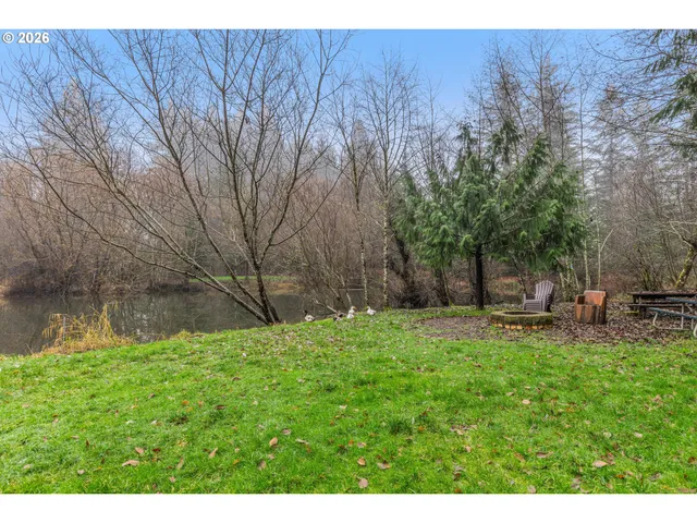 a backyard of a house with table and chairs