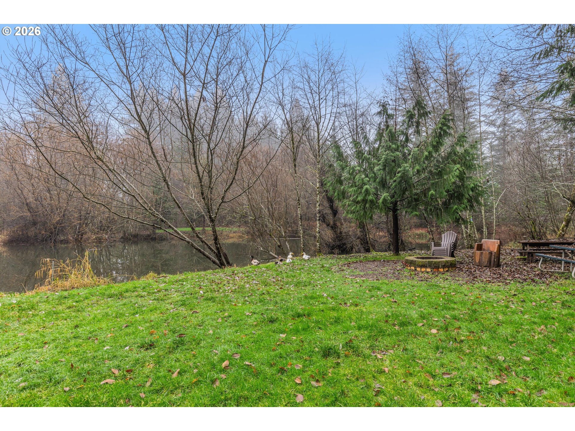 52365 Northwest Scofield Road Buxton, OR 97109 - Photo 37 of 48 a backyard of a house with table and chairs