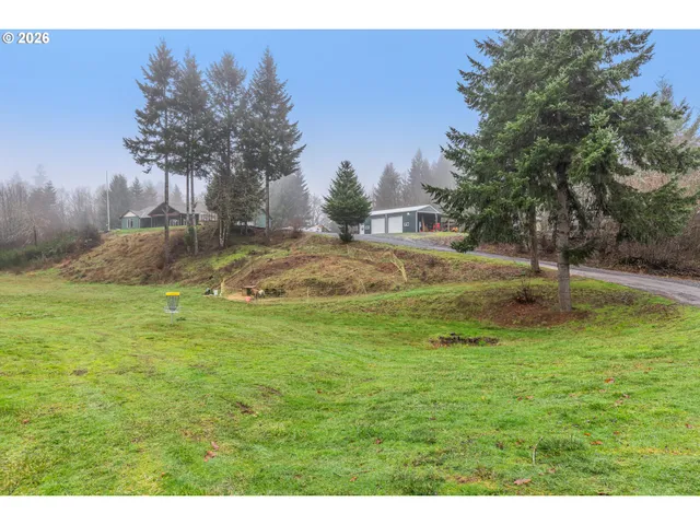 a backyard of a house with table and chairs