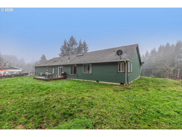 a backyard of a house with table and chairs