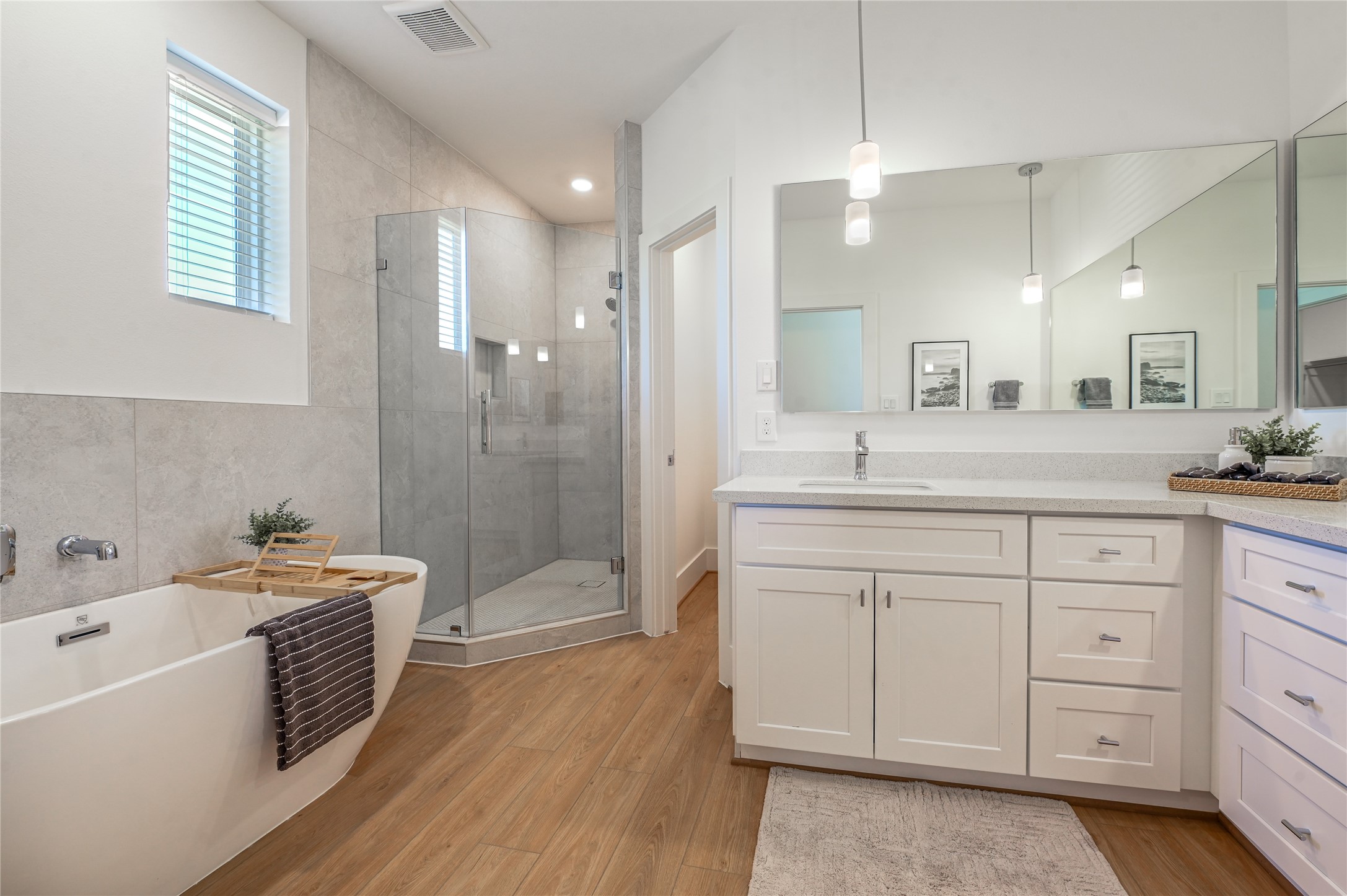 7607 Victory Reserve Street Houston, TX 77088 - Photo 29 of 50 a spacious bathroom with a double vanity sink a mirror a bathtub and shower