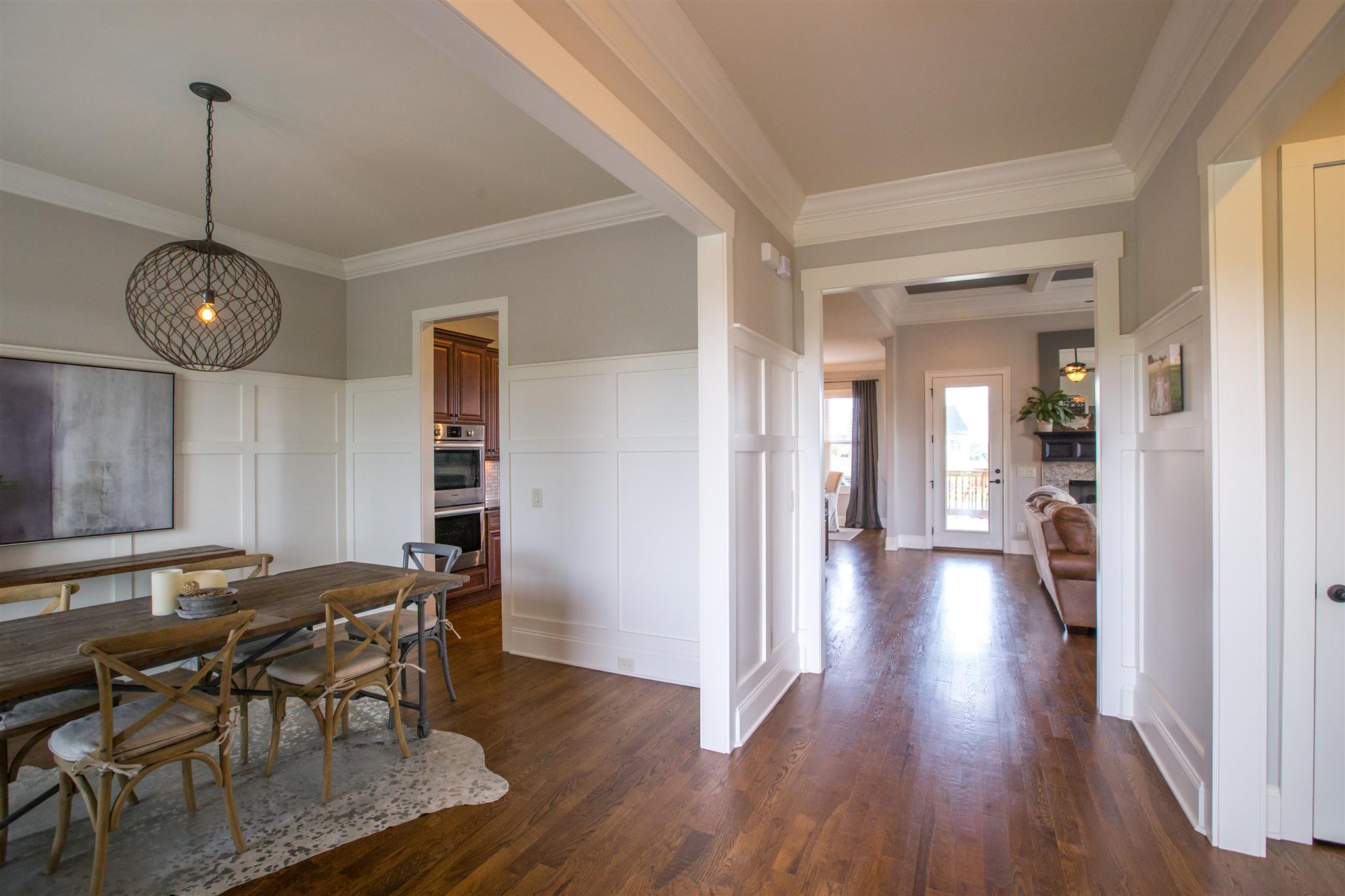 100 Truman Road West Franklin, TN 37064 - Photo 3 of 24 a view of a dining room and livingroom with furniture wooden floor a chandelier
