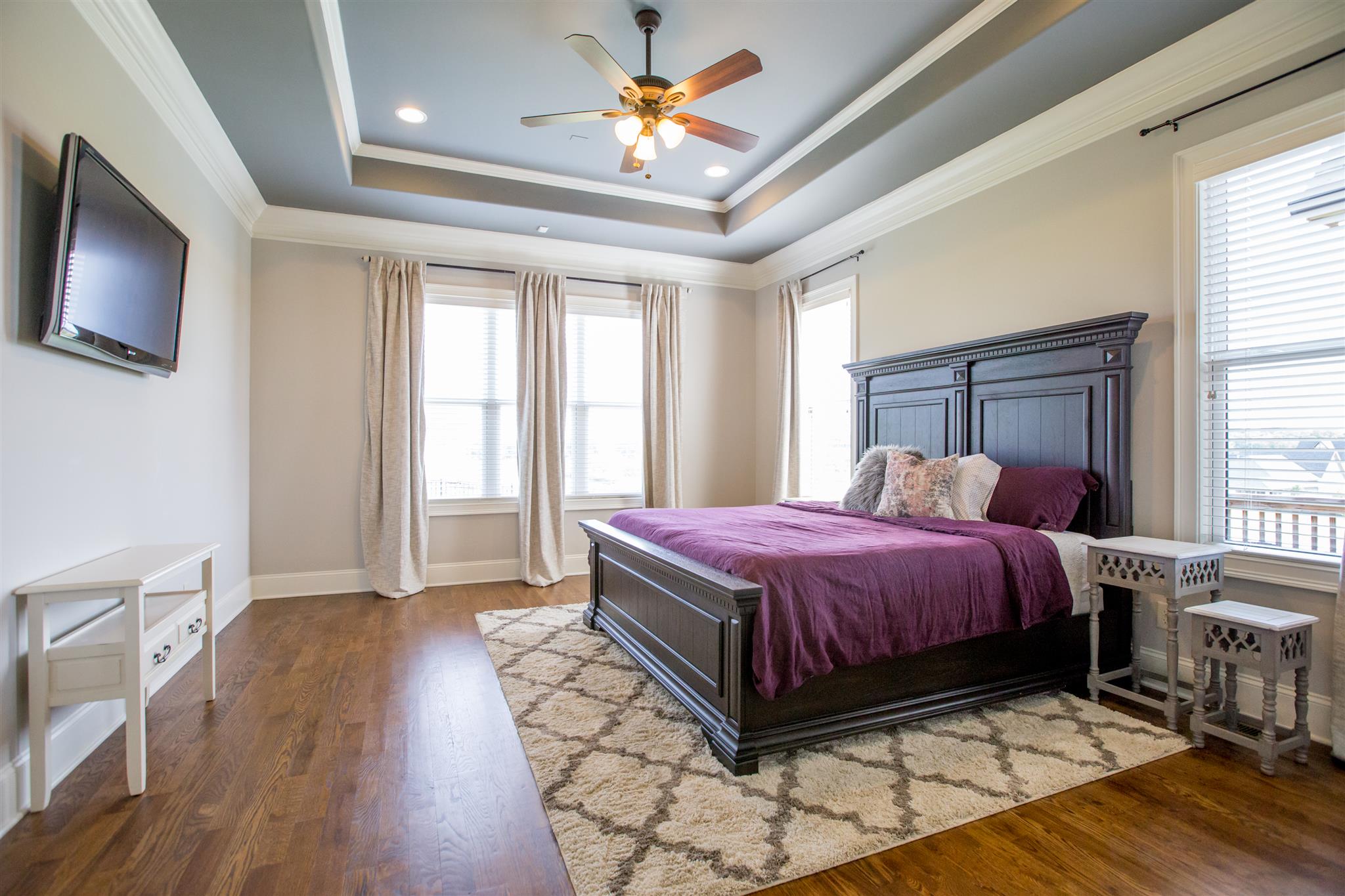 100 Truman Road West Franklin, TN 37064 - Photo 8 of 24 a spacious bedroom with a bed and a flat screen tv