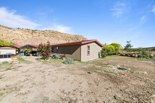 3135 North Thompson Cyn Road Green River, UT 84525 - Photo 36 of 41 View of home's exterior with a detached carport and a mountain view
