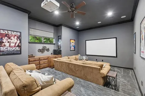 a living room with furniture and paintings on wall