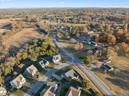 an aerial view of residential houses with city view