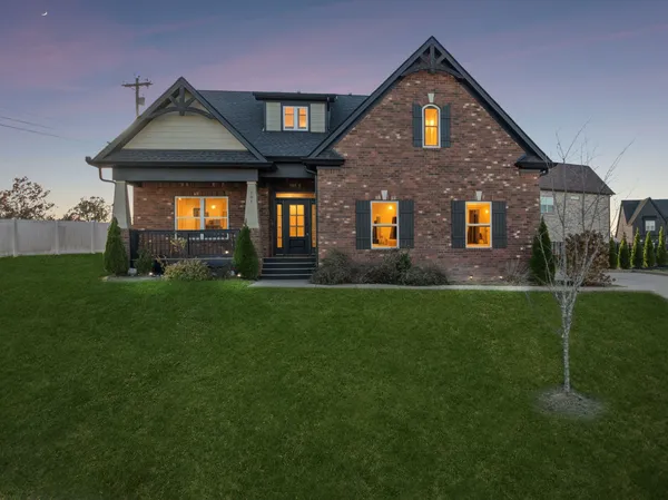 a front view of a house with a yard and garage