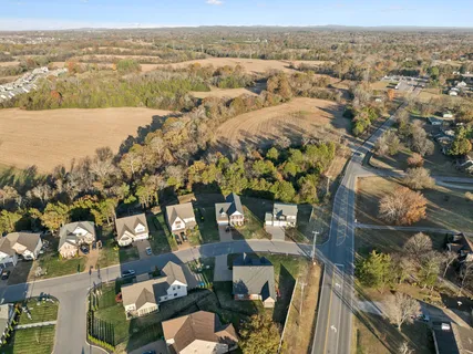 an aerial view of lake and residential houses with outdoor space