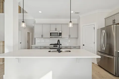 a view of a kitchen with a sink stainless steel appliances and cabinets