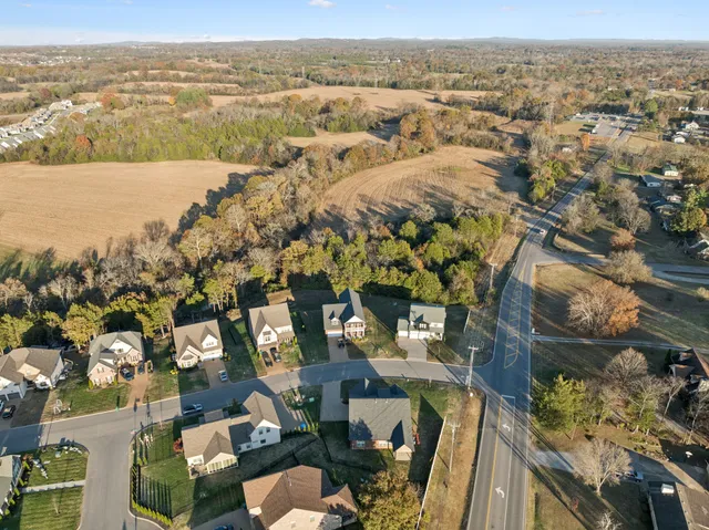 an aerial view of lake and residential houses with outdoor space
