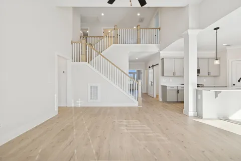 a view of an empty room with a fireplace and a window