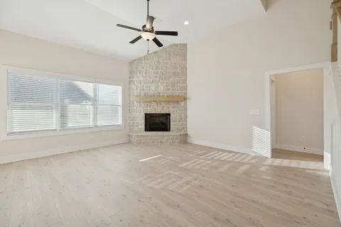 a view of a room with wooden floor and a window