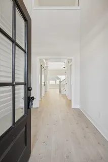 a view of entryway and hall with a front door