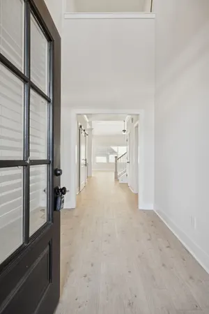 a view of entryway and hall with a front door