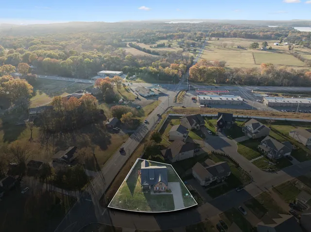 an empty room with a ceiling fan and window