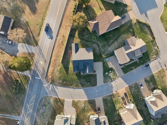 an empty room with a window and a ceiling fan
